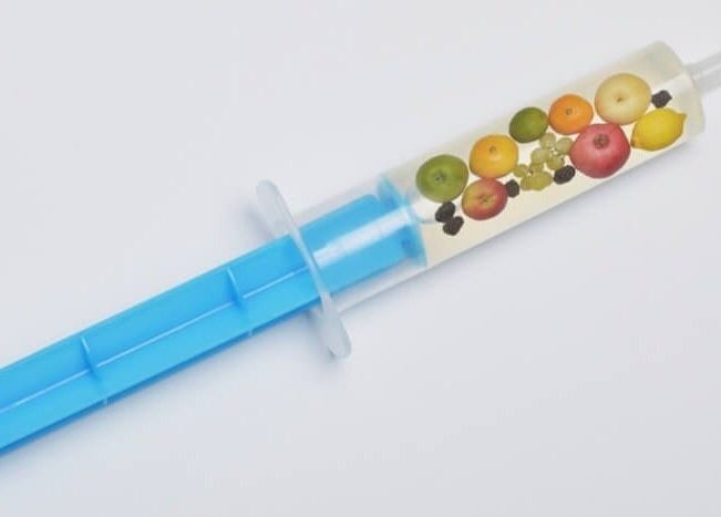 Colorful fruit infusion syringe at Healthy Living Colorado, Aurora, Colorado, US, showcasing wellness and vitality.