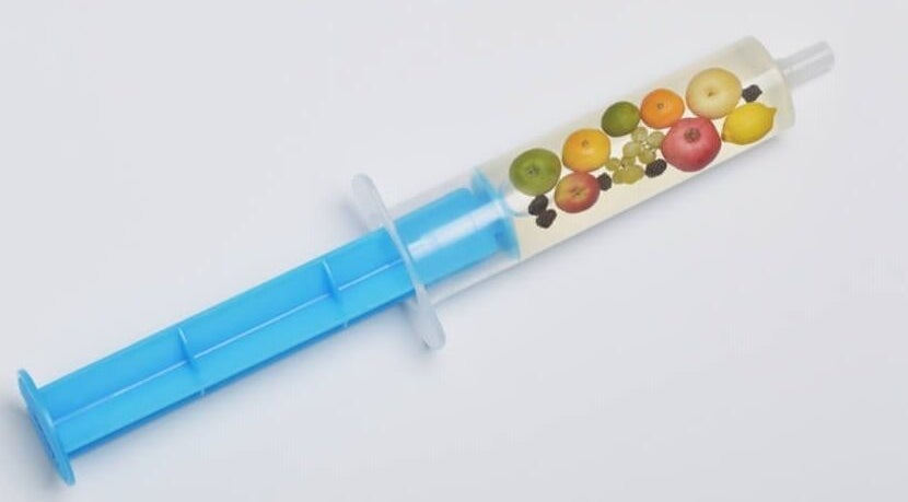 Colorful fruit infusion syringe at Healthy Living Colorado, Aurora, Colorado, US, showcasing wellness and vitality.