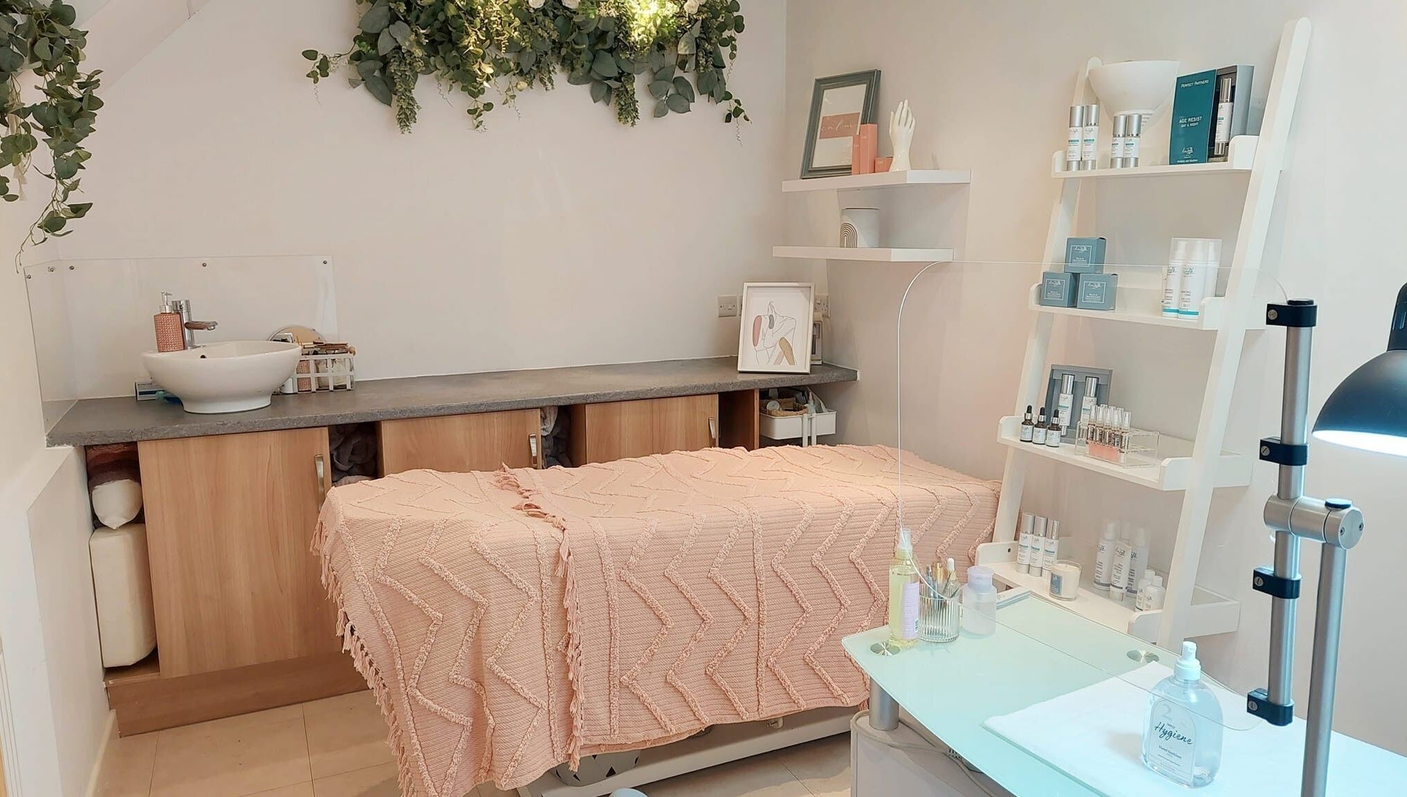 Serene treatment room at Coco Beauty, Belper, England, GB with soft decor and skincare products.