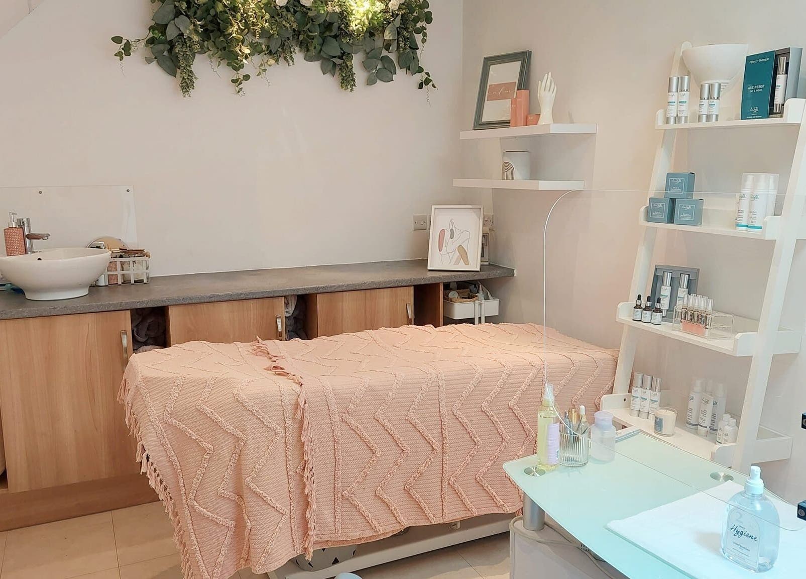 Serene treatment room at Coco Beauty, Belper, England, GB with soft decor and skincare products.
