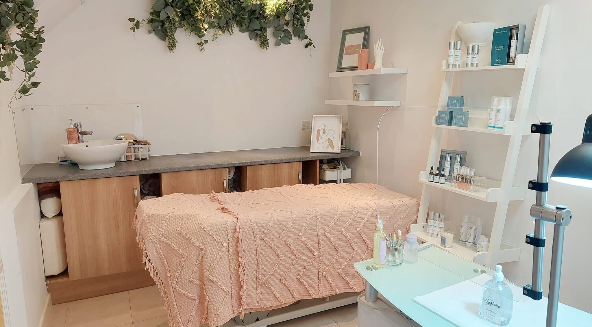 Serene treatment room at Coco Beauty, Belper, England, GB with soft decor and skincare products.