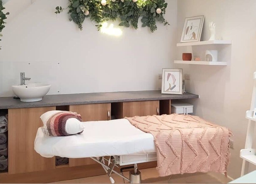 Tranquil treatment room at Coco Beauty in Belper, England, GB with plush bedding and elegant decor.