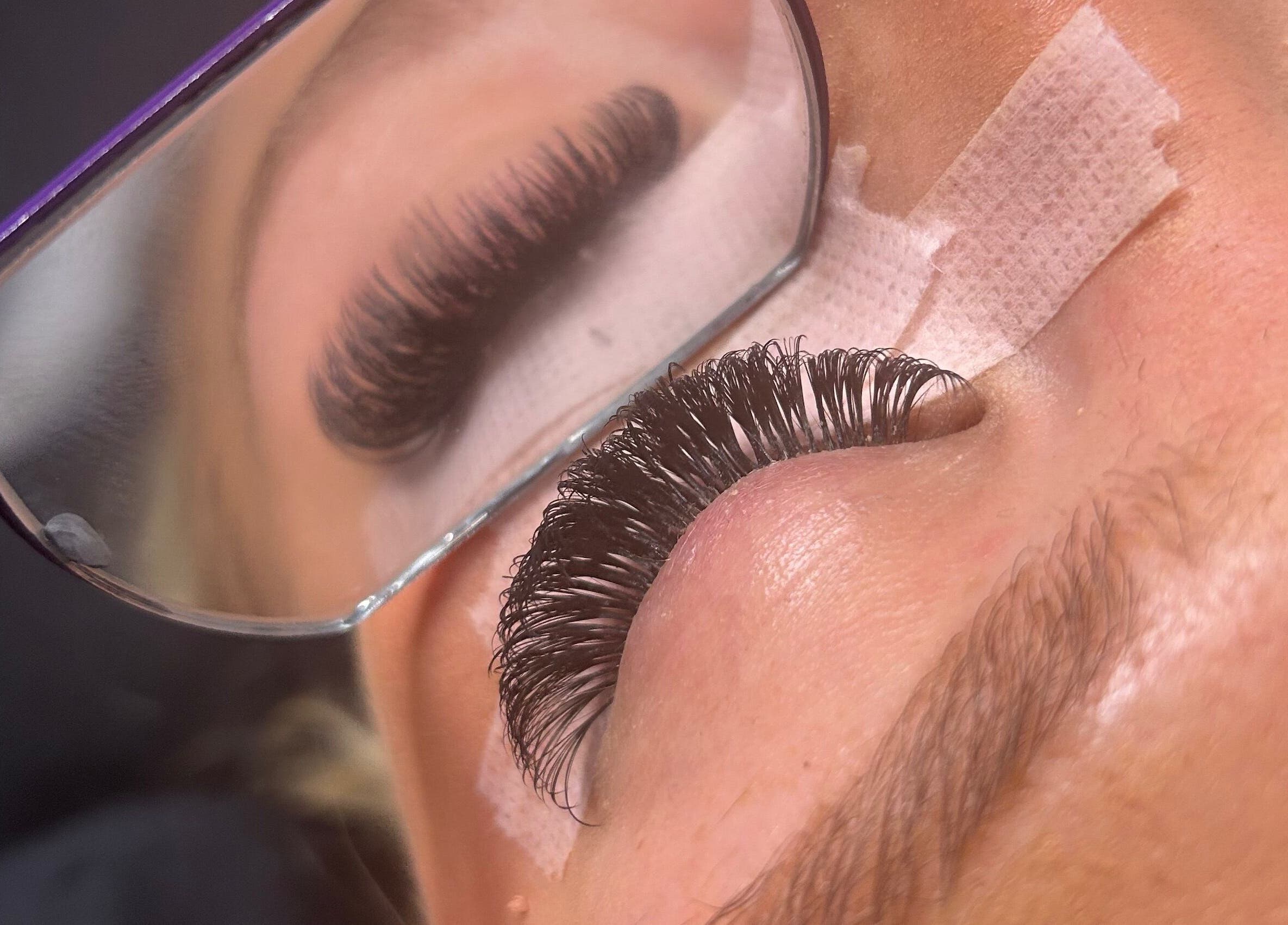 Close-up of eyelash extensions at LylaLash, Matson, England, GB, mirrored in stylist's glasses.