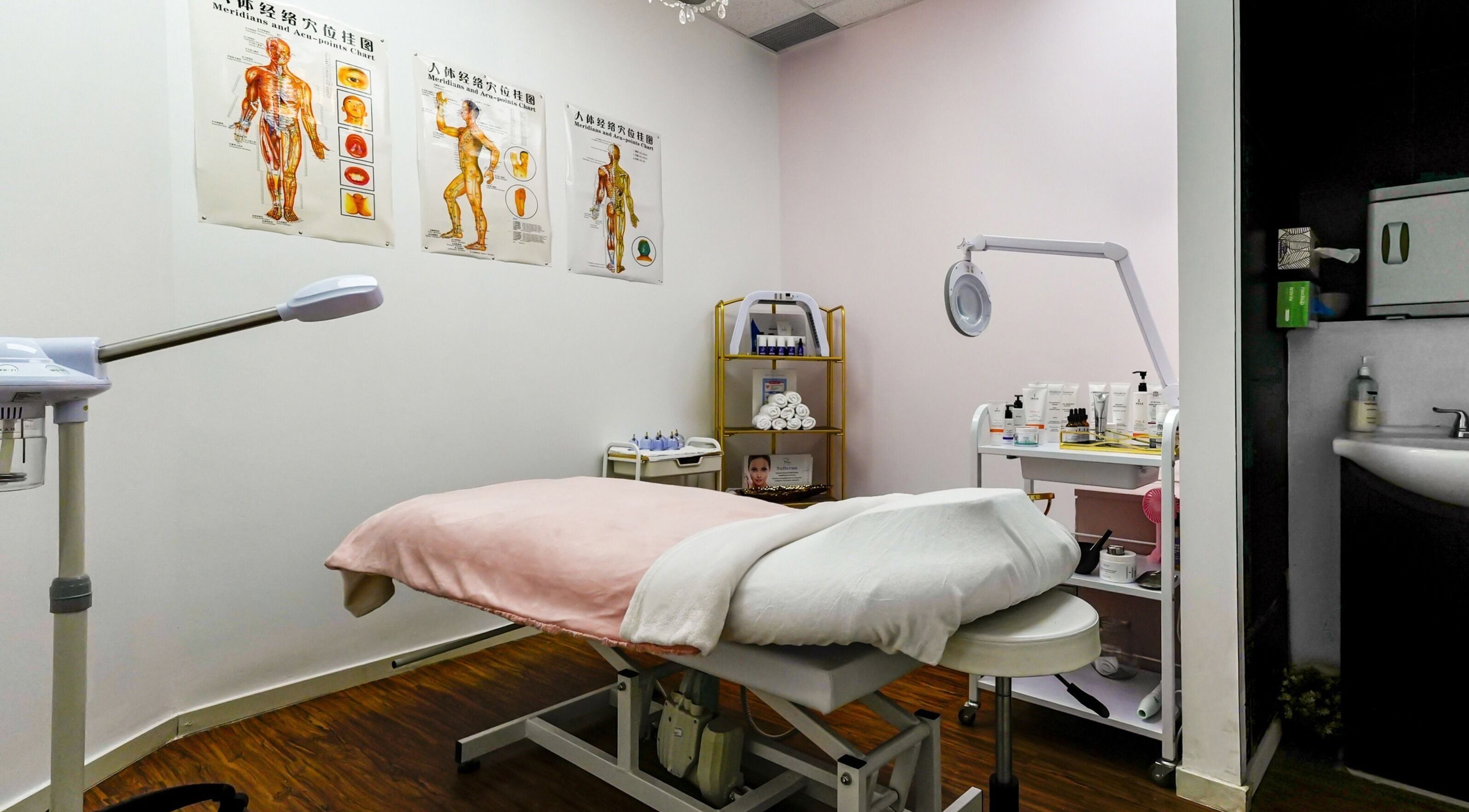Serene treatment room at Blanche Neige Laser, Burnaby, British Columbia, CA with massage table and equipment.