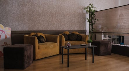 Espaço de espera confortável no Zen Spa, Tomar, Santarém, PT, com sofás elegantes e decoração suave.