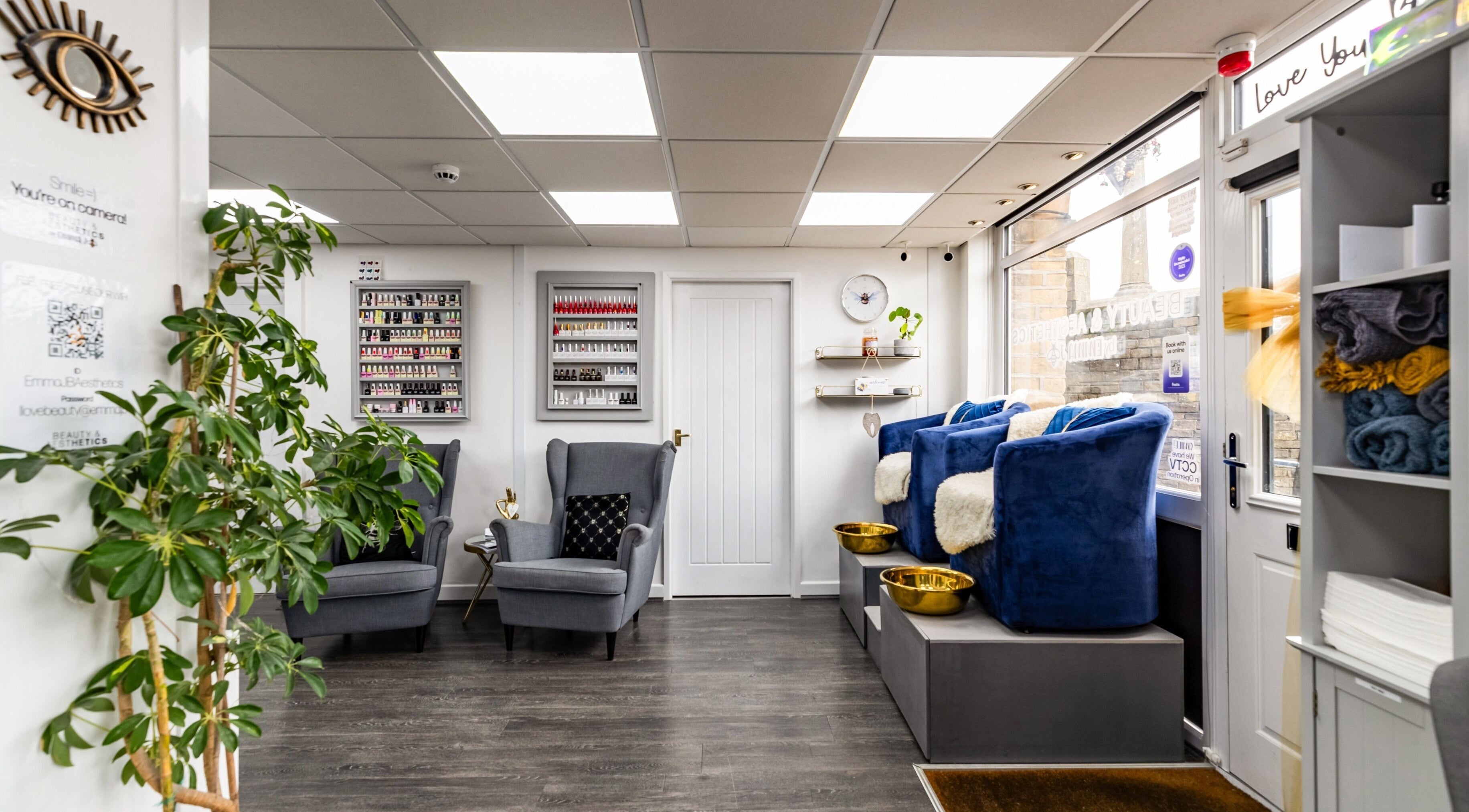 Inviting interior of Beauty & Aesthetics by Emma JB in Queensbury, England, featuring elegant chairs and soft lighting.