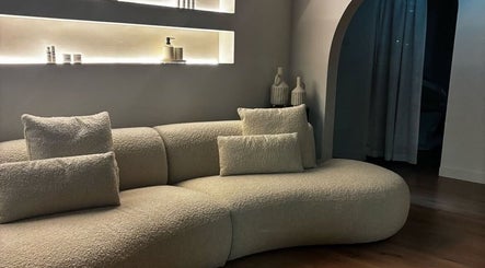Elegant curved sofa in tranquil room at Aesthetics by Siobhan, Belfast, Northern Ireland, GB.