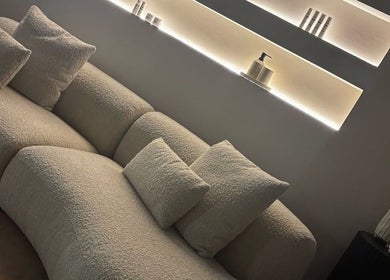 Elegant lounge area at Aesthetics by Siobhan, Belfast, Northern Ireland, GB, showcasing a plush cream sofa.