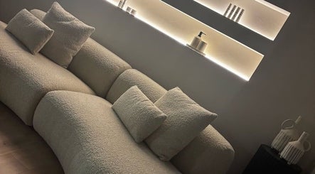 Elegant lounge area at Aesthetics by Siobhan, Belfast, Northern Ireland, GB, showcasing a plush cream sofa.