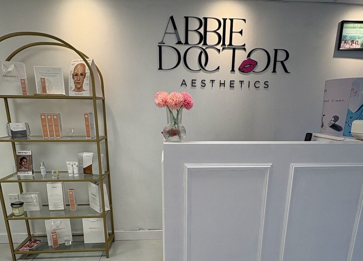 Reception area of Abbie Doctor Aesthetics in Gloucester, England, GB showcasing modern decor and product display.
