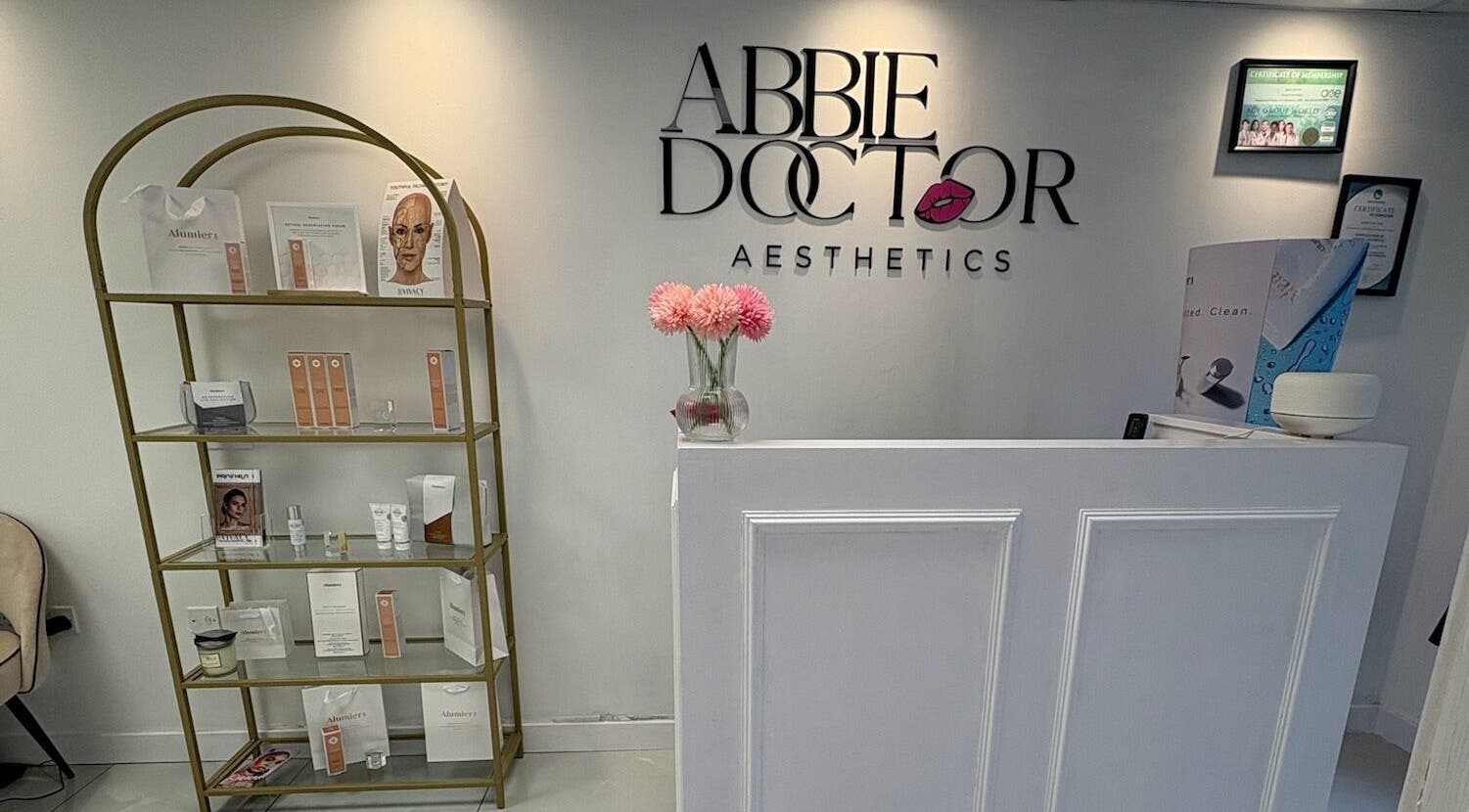 Reception area of Abbie Doctor Aesthetics in Gloucester, England, GB showcasing modern decor and product display.