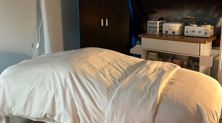 Cozy massage room at Ease Esthetics & Massage in Tulsa, Oklahoma, US offering a serene relaxation experience.