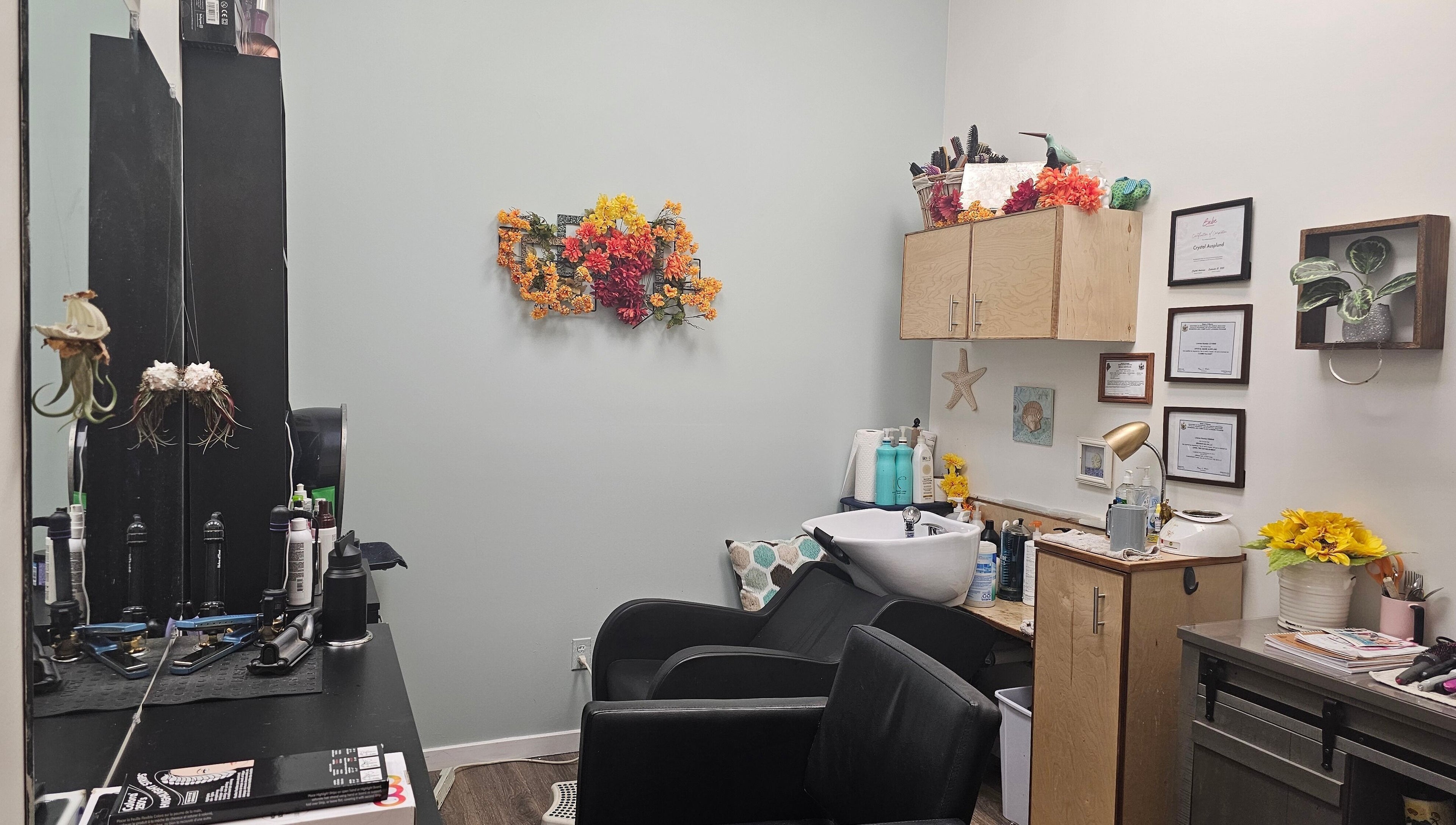 Cozy salon setup at Salon Suites by the Sea, Rockport, Maine, US, with vibrant floral decor and hair styling tools.