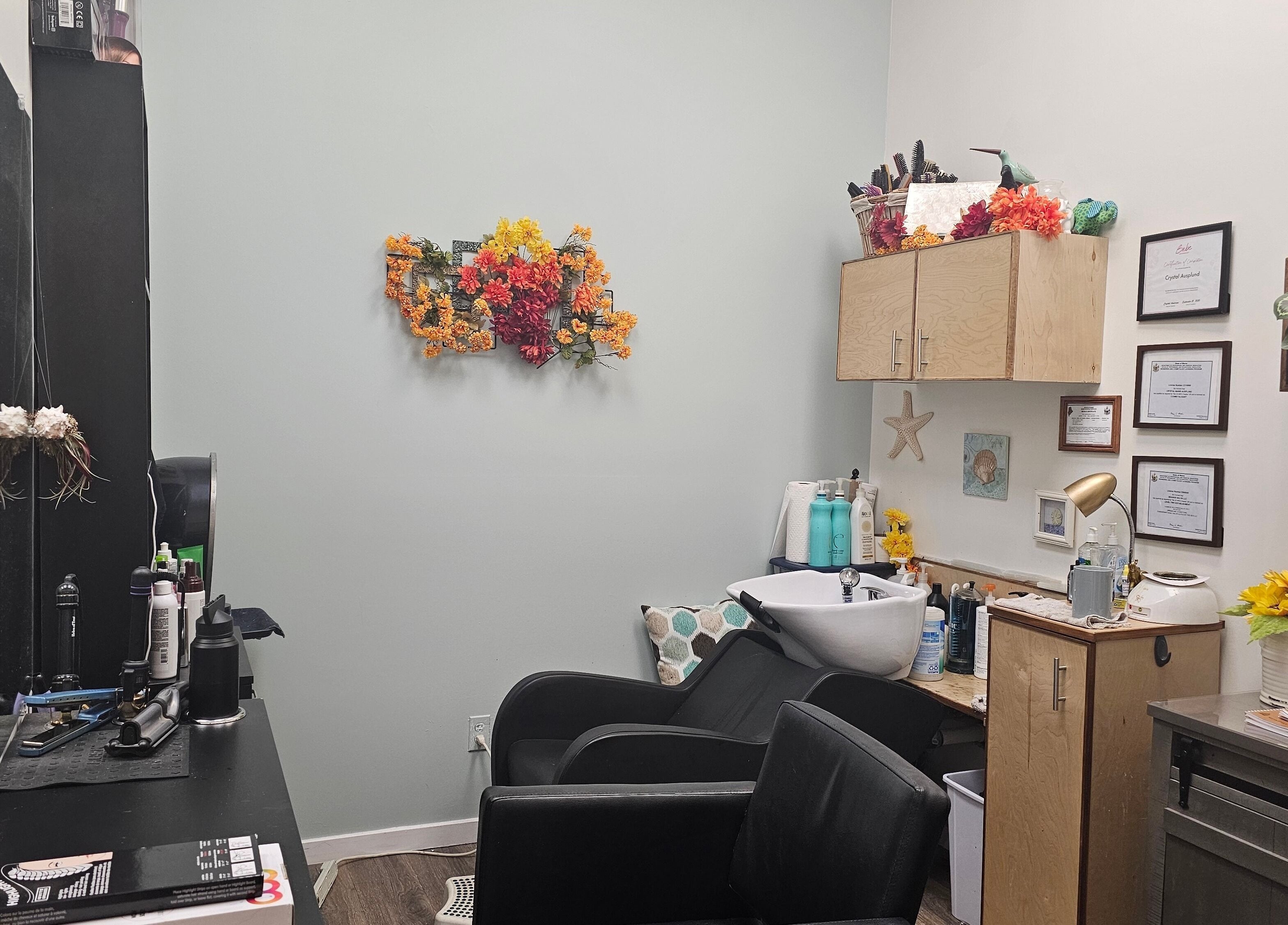 Cozy salon setup at Salon Suites by the Sea, Rockport, Maine, US, with vibrant floral decor and hair styling tools.