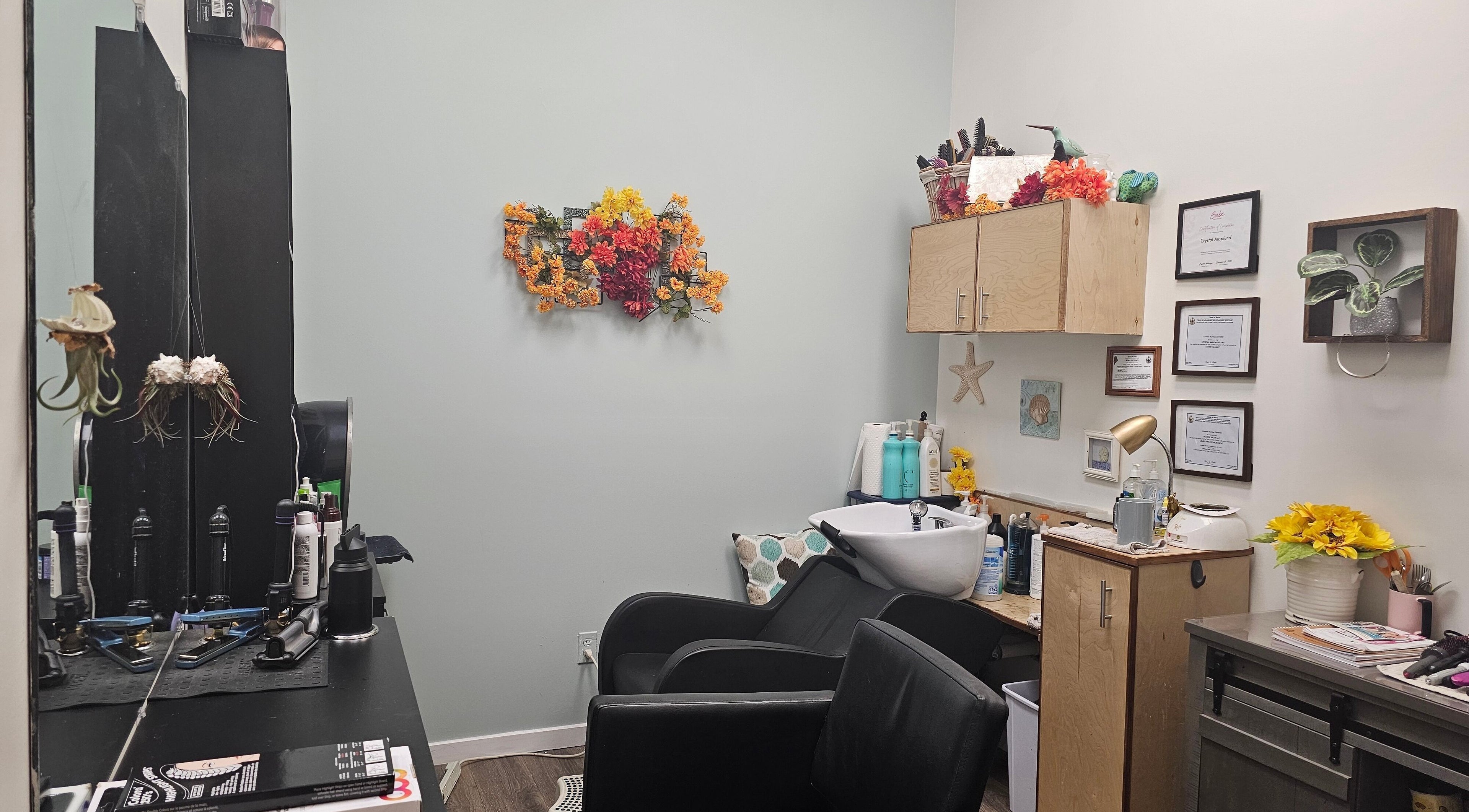 Cozy salon setup at Salon Suites by the Sea, Rockport, Maine, US, with vibrant floral decor and hair styling tools.