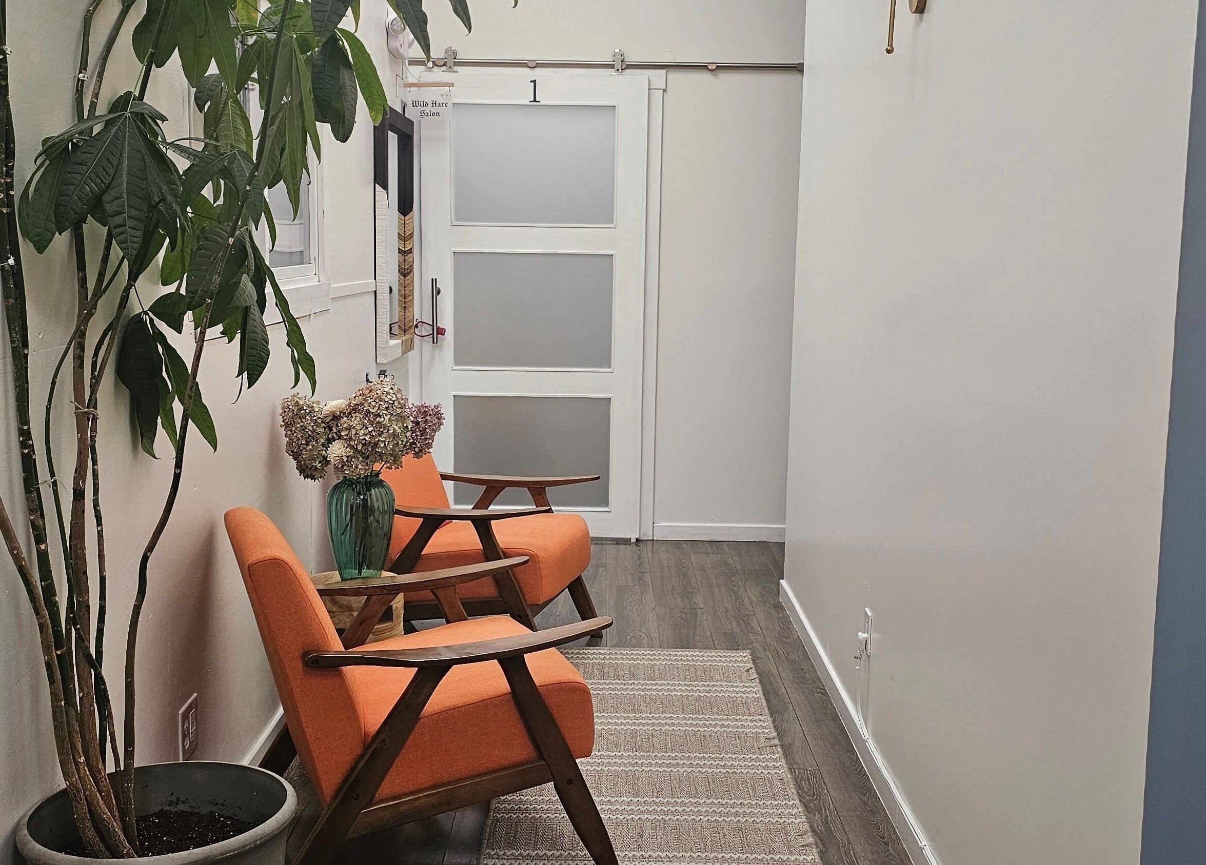 Bright hallway with seating at Seaside at Salon Suites by the Sea, Rockport, Maine, US.