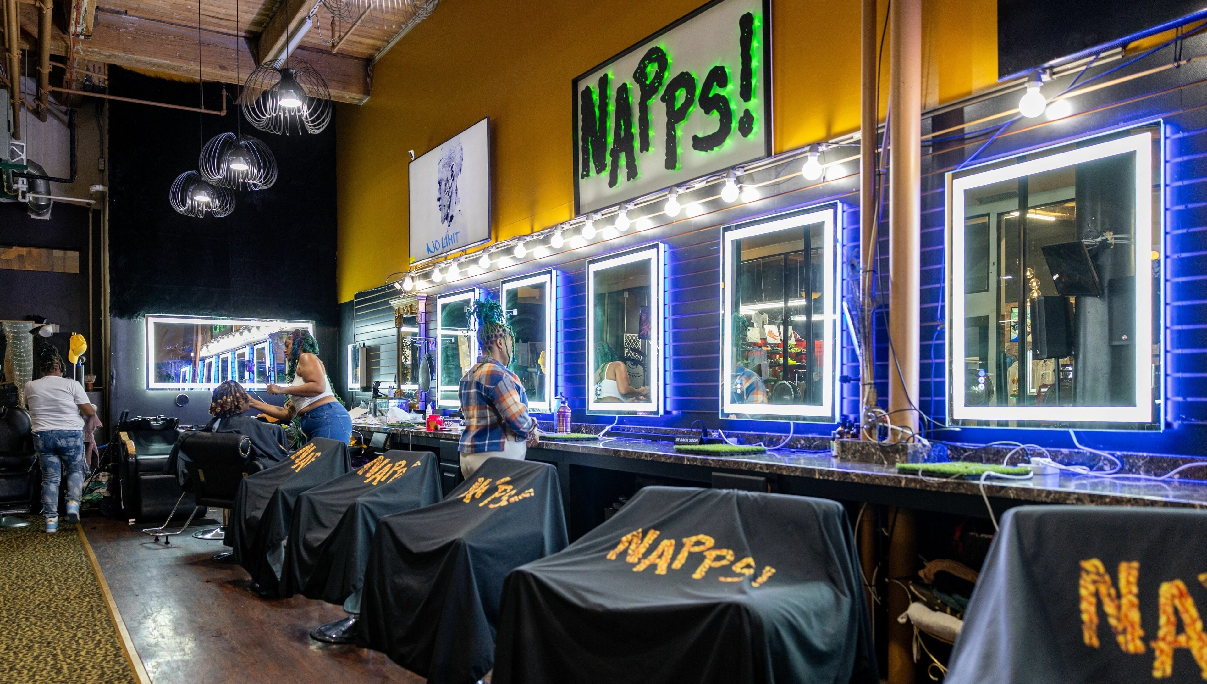 Stylish interior of Napps Natural Hair Salon in St. Louis, Missouri, US featuring modern lighting and station setup.