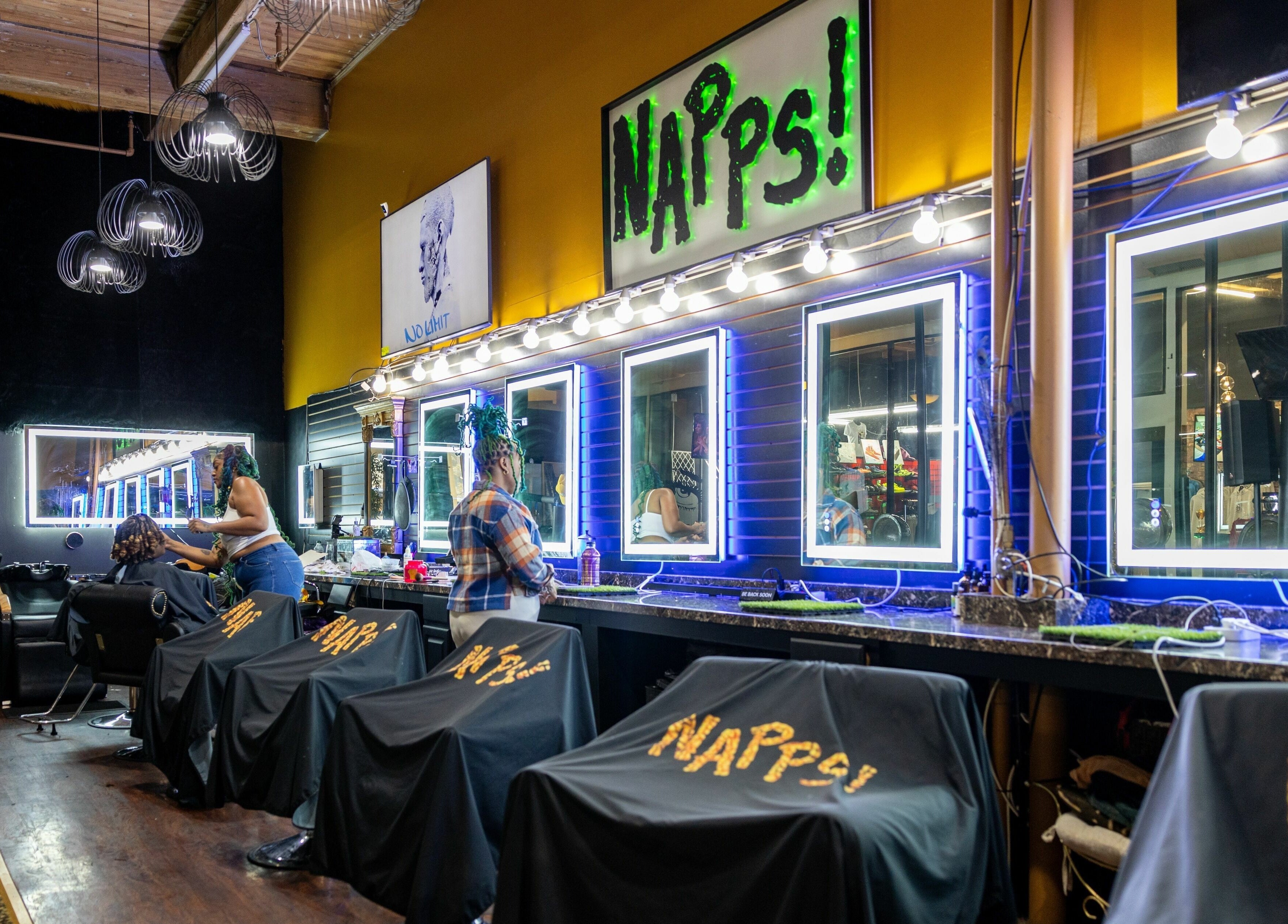Stylish interior of Napps Natural Hair Salon in St. Louis, Missouri, US featuring modern lighting and station setup.
