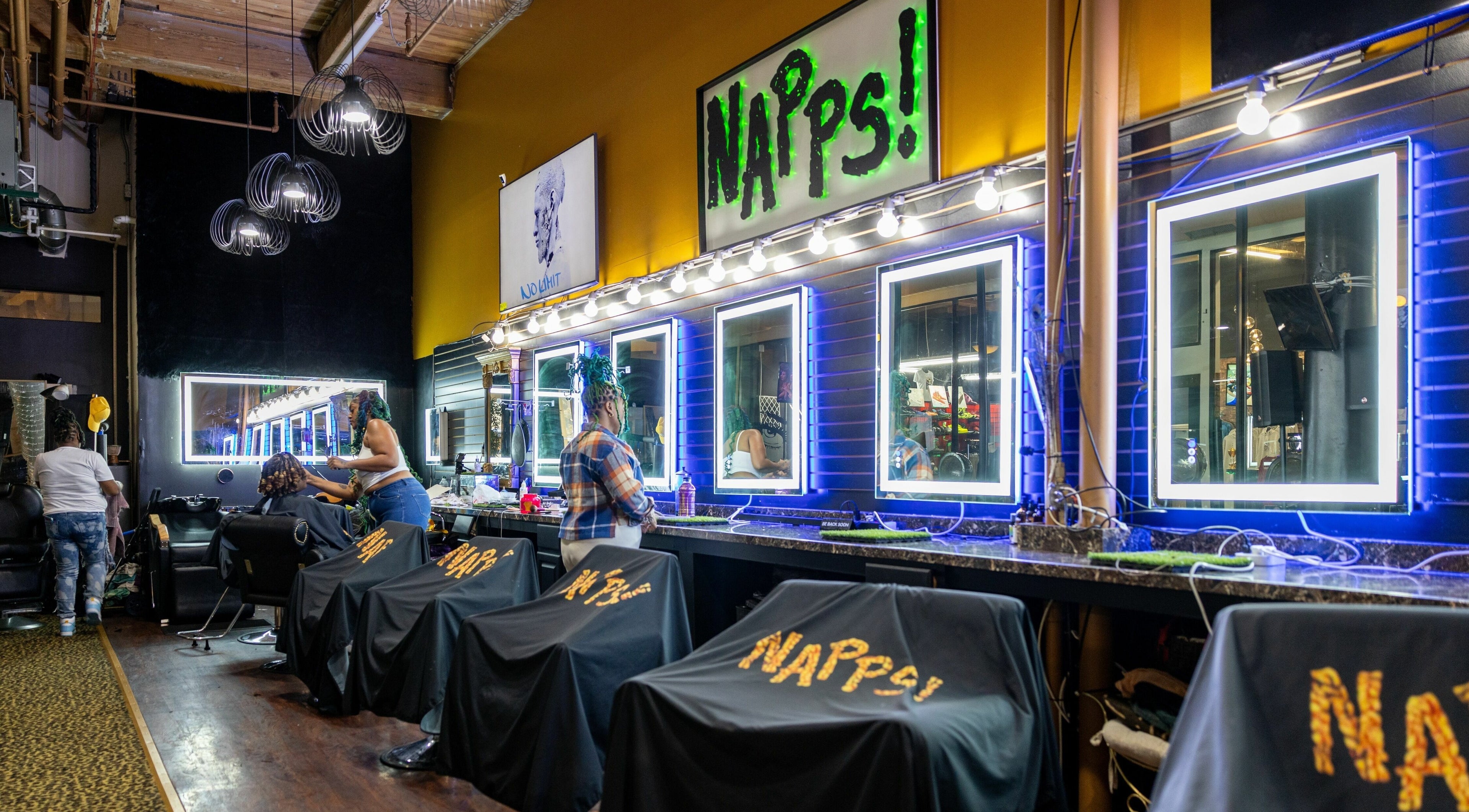 Stylish interior of Napps Natural Hair Salon in St. Louis, Missouri, US featuring modern lighting and station setup.