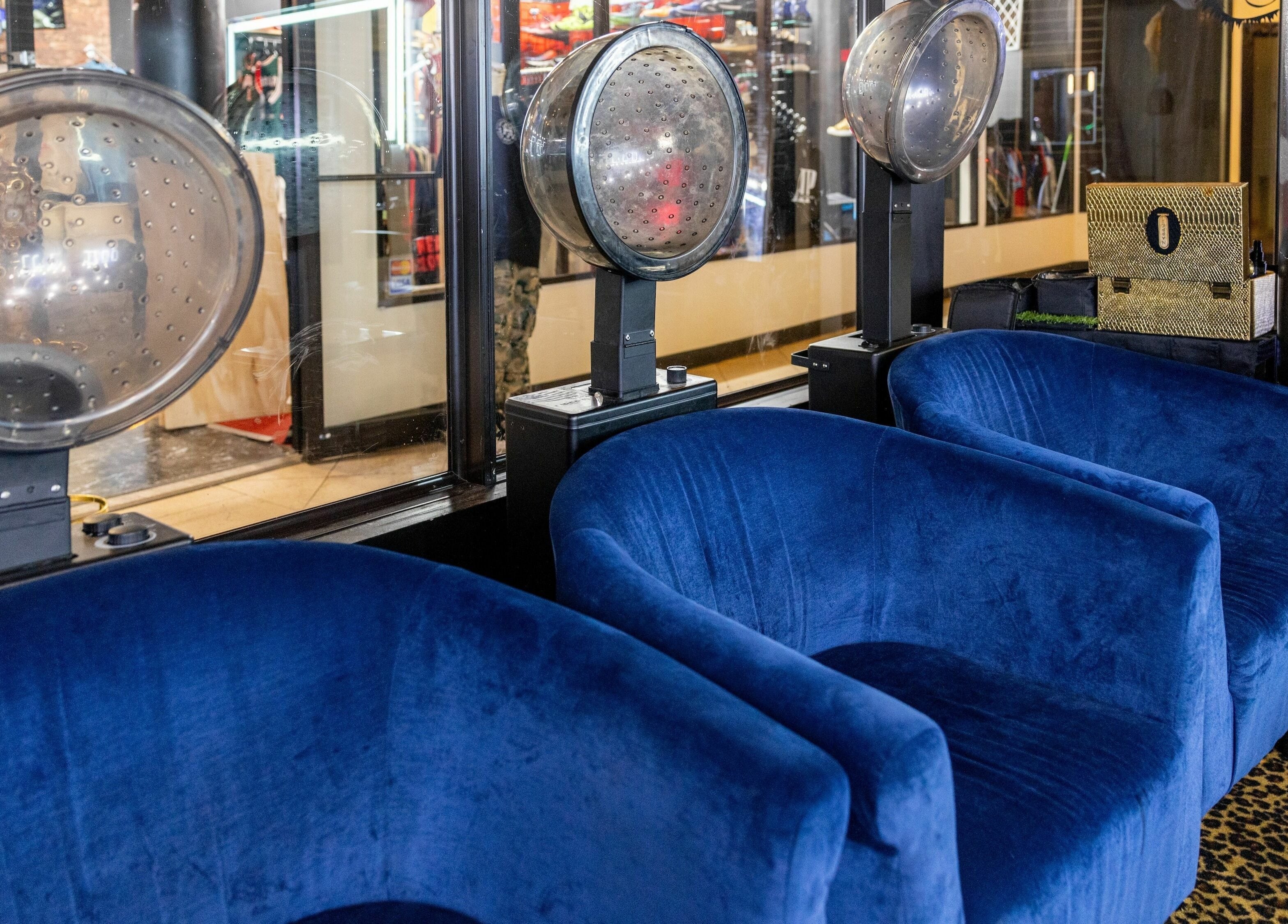Modern blue seating at Napps Natural Hair Salon in St. Louis, Missouri, US, offering a stylish, relaxing ambiance.