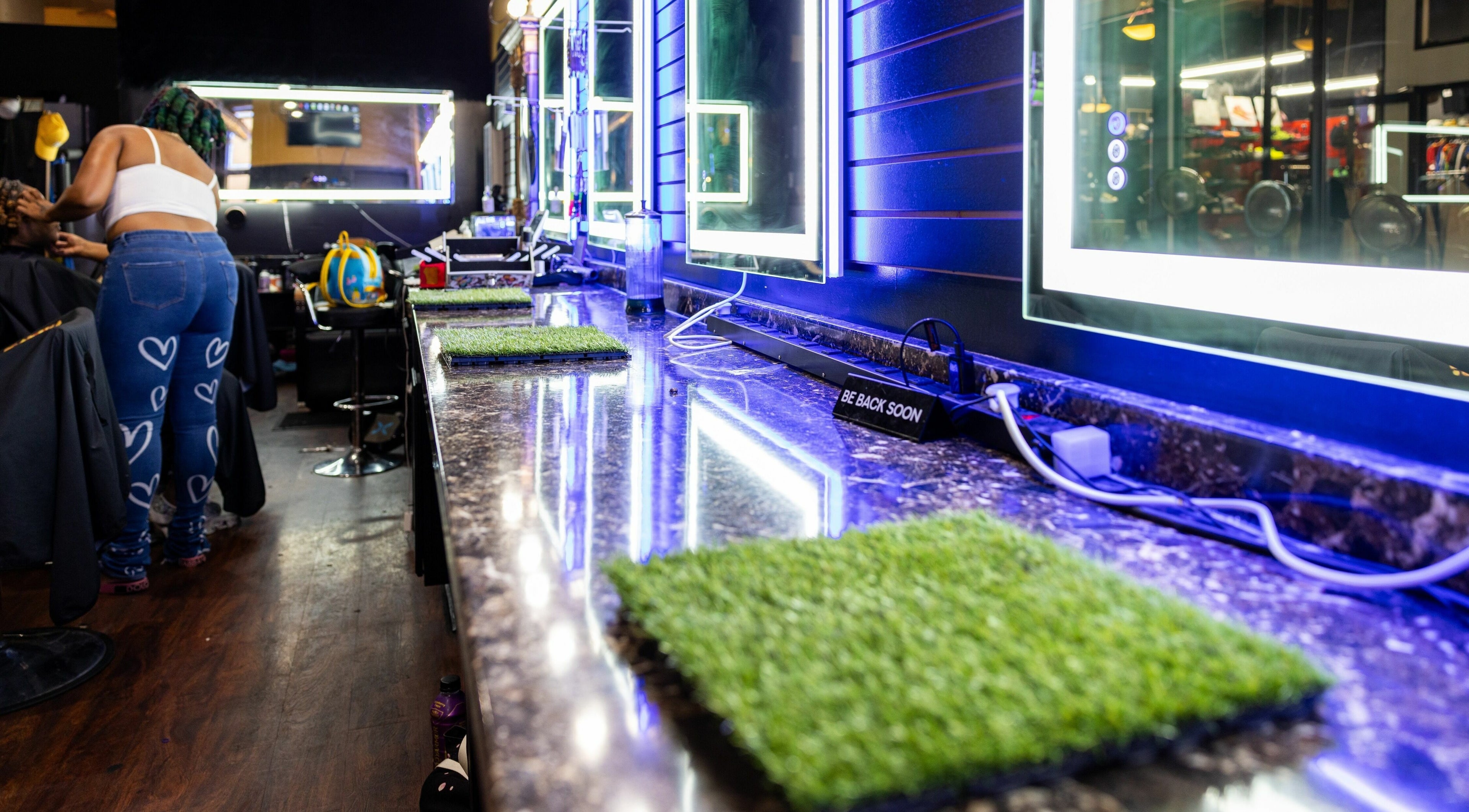 Inside view of Napps Natural Hair Salon, St. Louis, Missouri, US with illuminated mirrors and styling area.