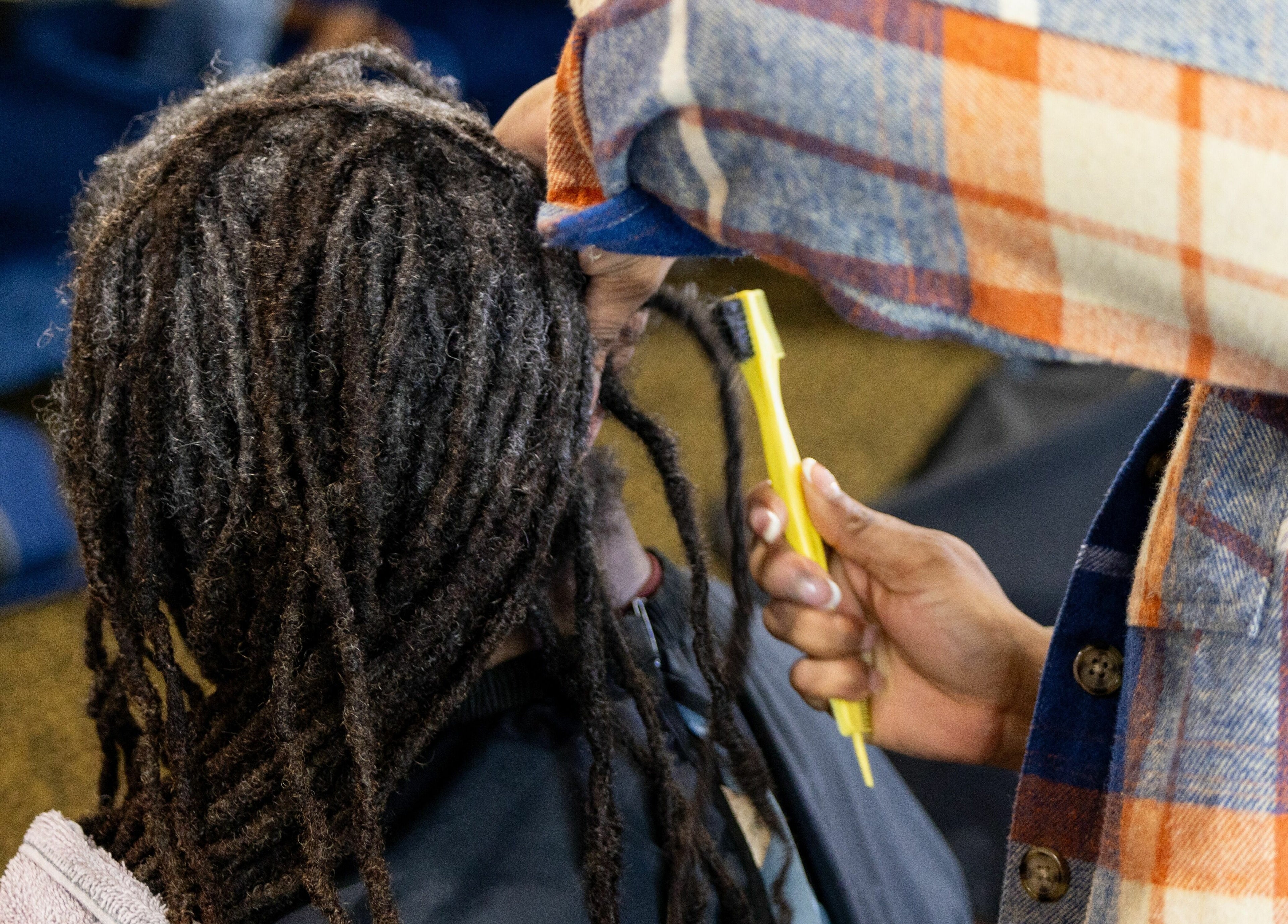 Stylist maintaining dreadlocks at Napps Natural Hair Salon, St. Louis, Missouri, US.