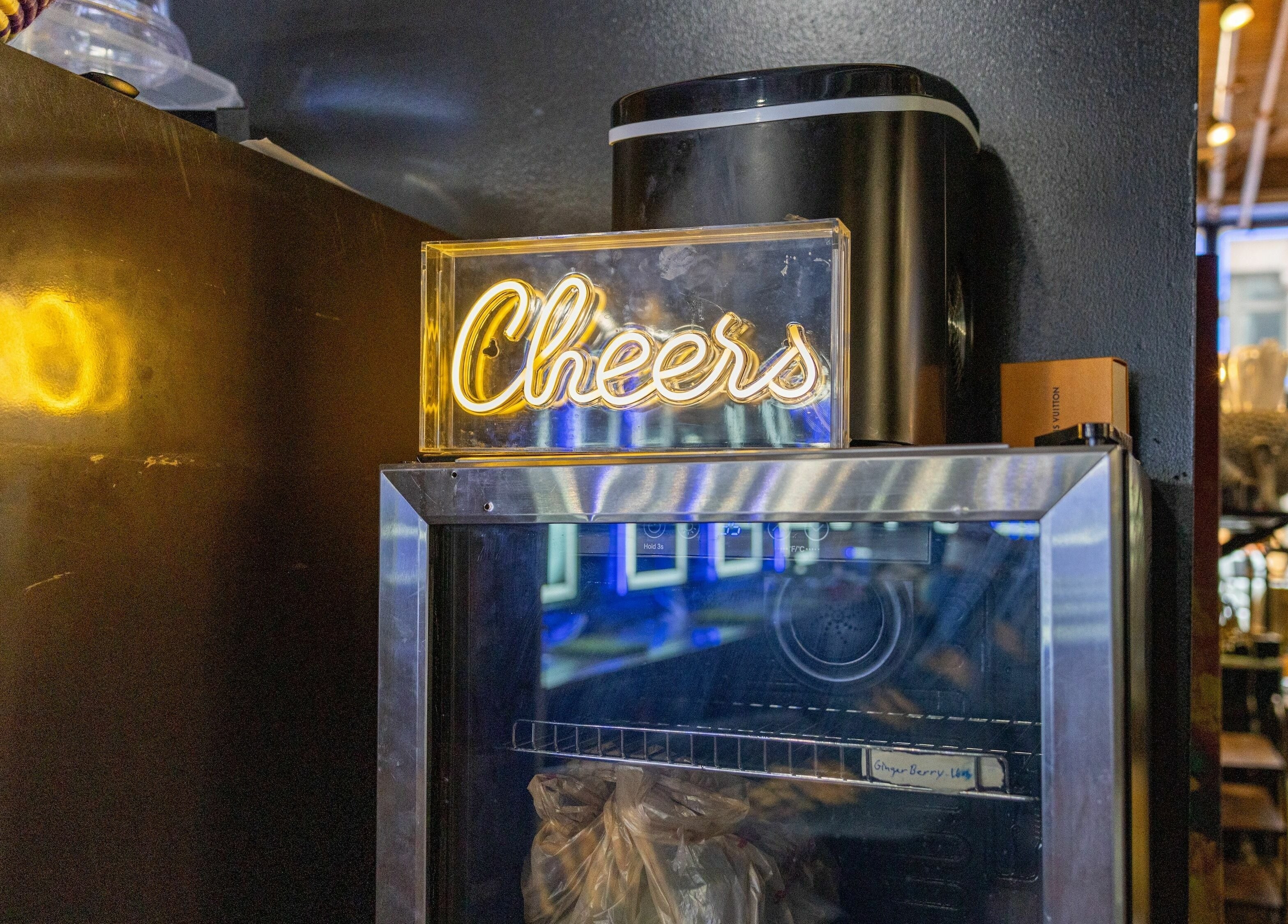 Illuminated 'Cheers' sign above a fridge at Napps Natural Hair Salon in St. Louis, Missouri, US.
