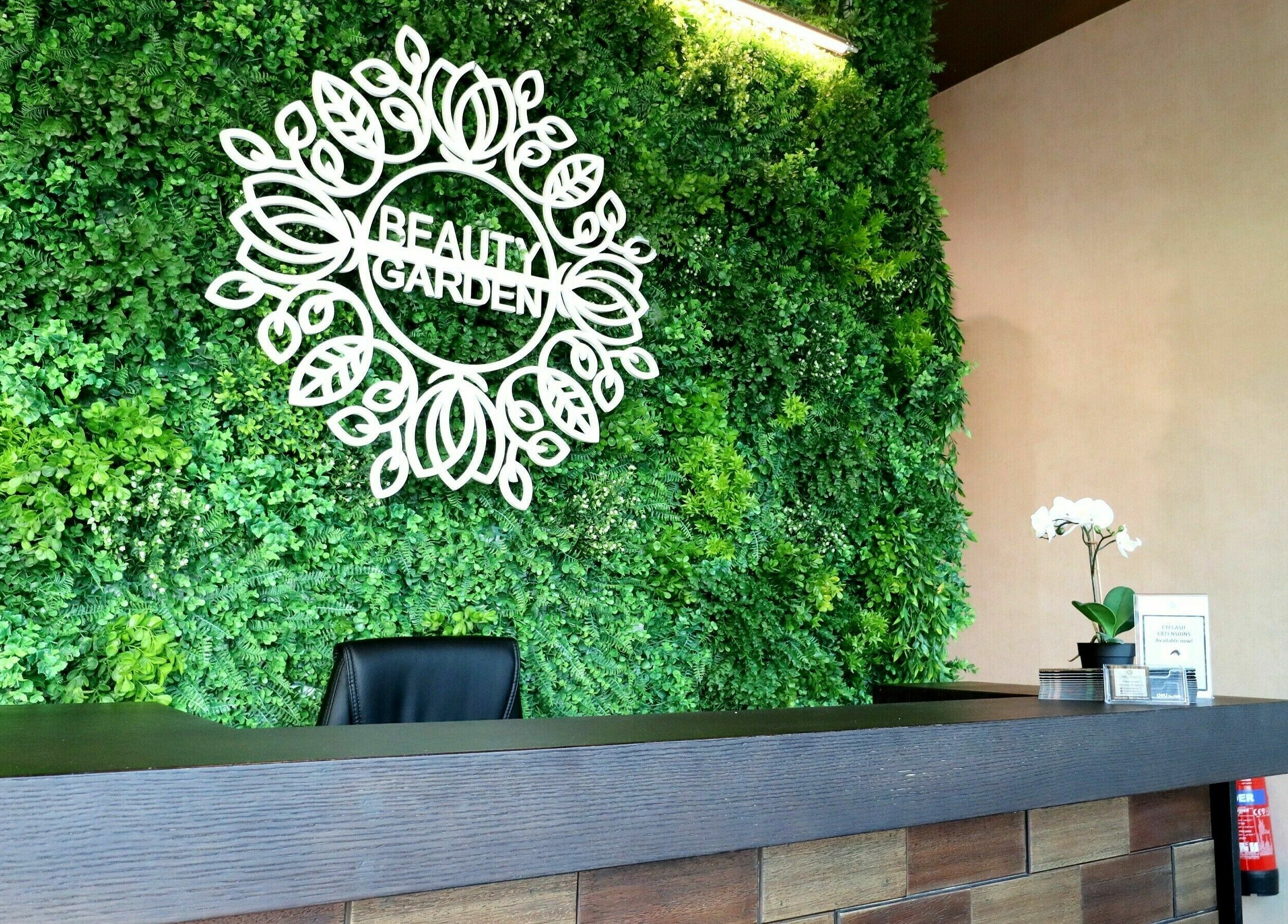 Entrance to Beauty Garden, Dubai, Dubai, AE with lush green backdrop and modern reception desk.