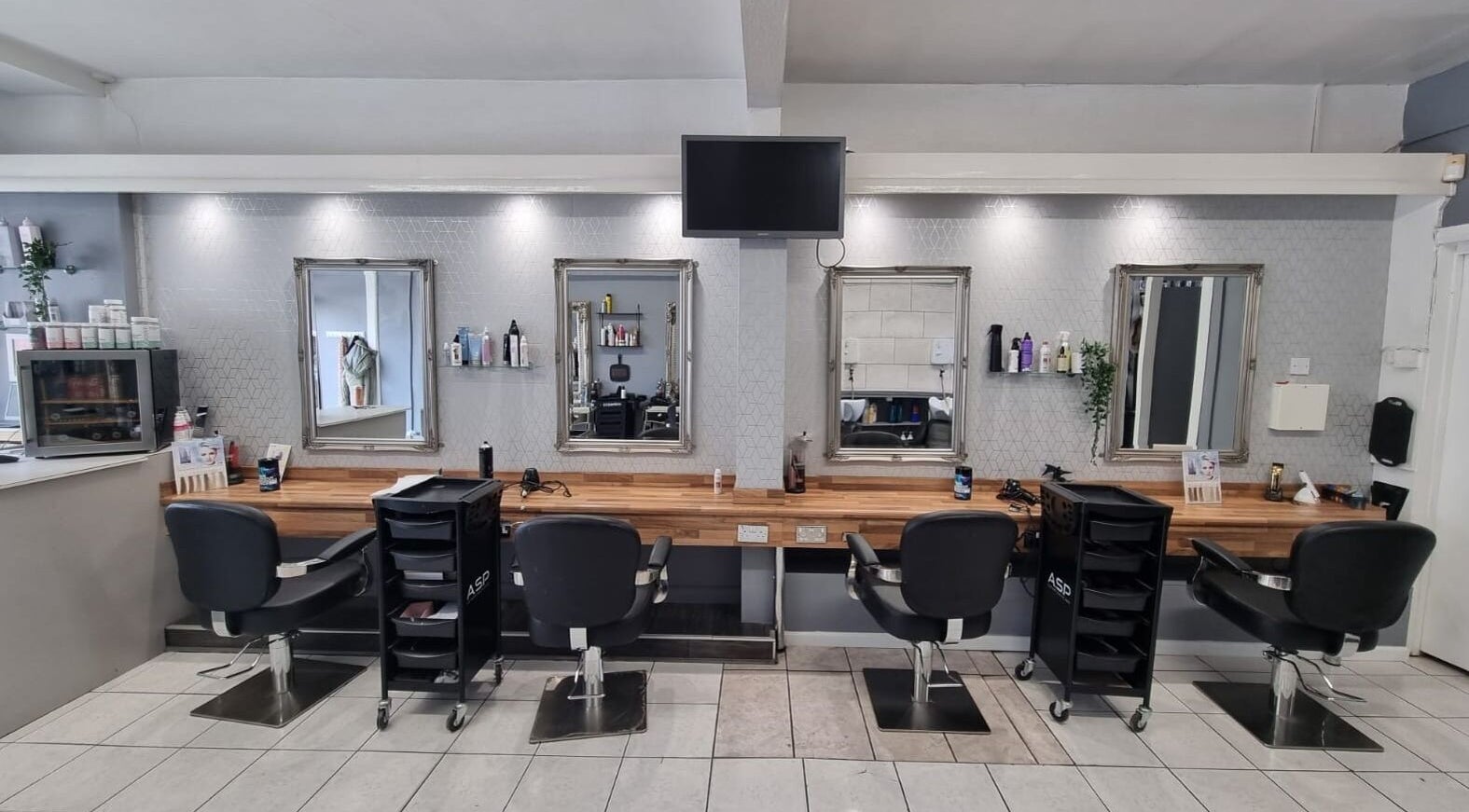 Styling area at Vibe Hair & Beauty in Coalville, England, GB showcasing modern chairs and elegant mirrors.