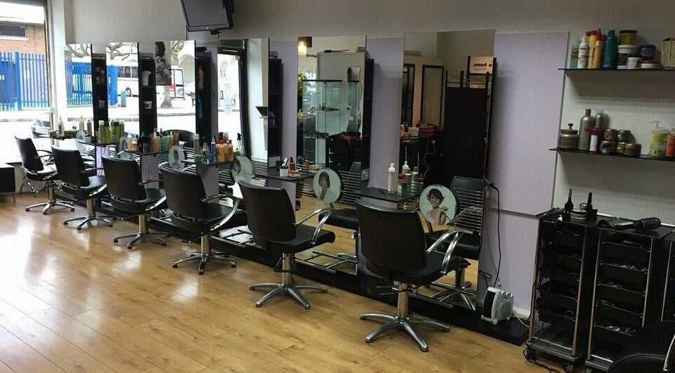 Modern styling chairs and mirrors at Natural Beauty Hair Salon in Ilford, England, GB.