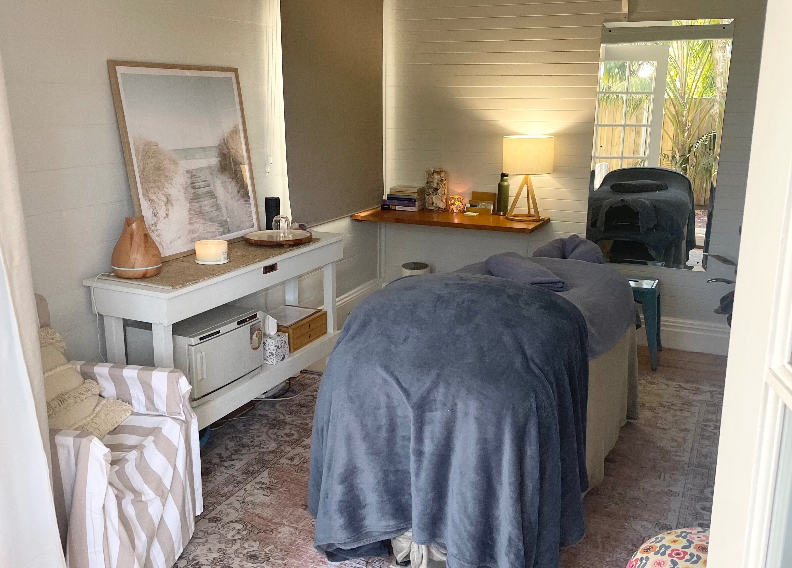 Cozy treatment room at Rebecca Orchard Remedial Massage in Hamilton, New South Wales, AU with a massage table.