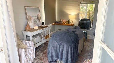 Cozy treatment room at Rebecca Orchard Remedial Massage in Hamilton, New South Wales, AU with a massage table.
