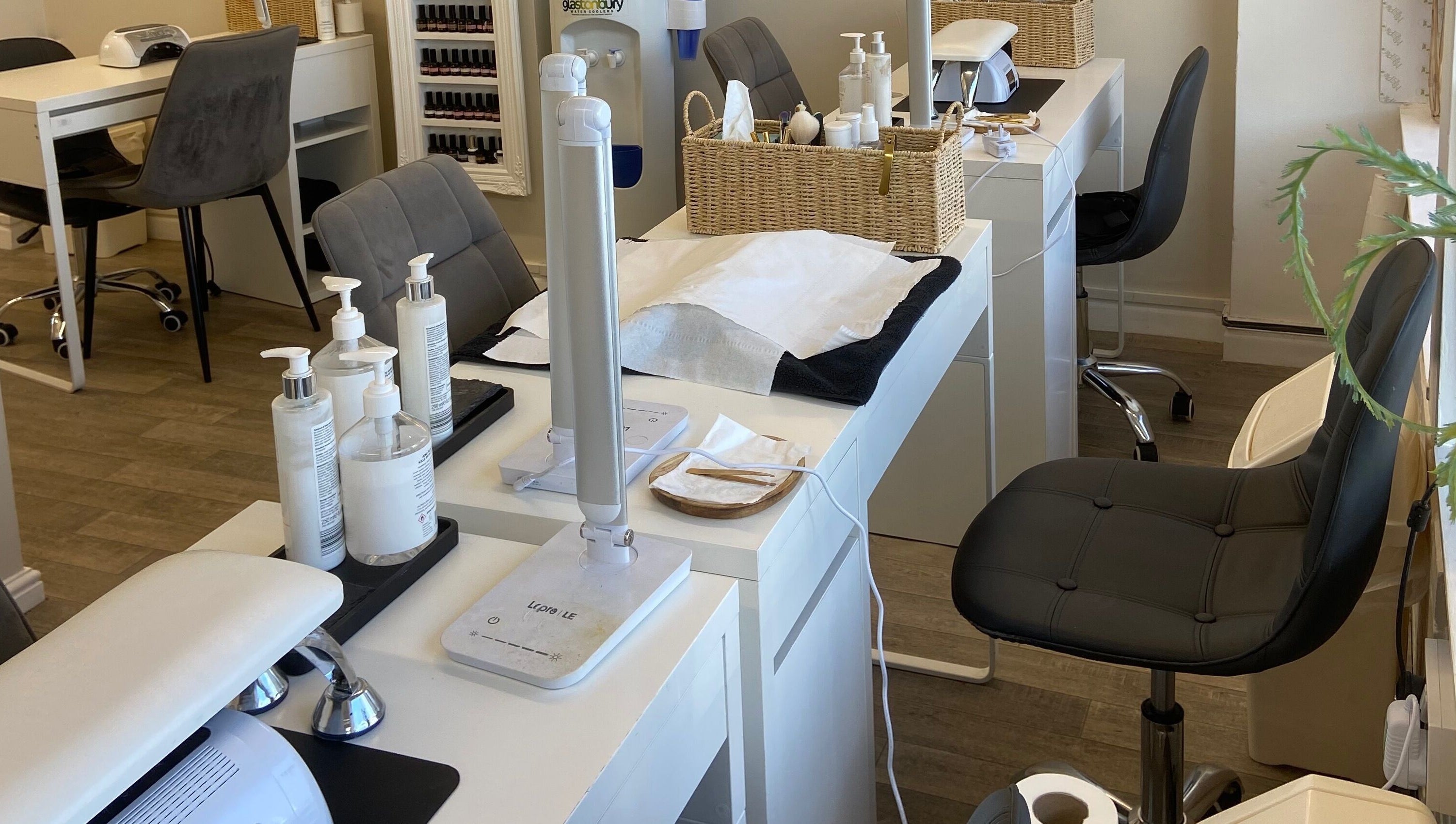 Elegant nail salon stations at Elm Tree Beauty in Westfield, England, GB, showcasing modern and tidy design.