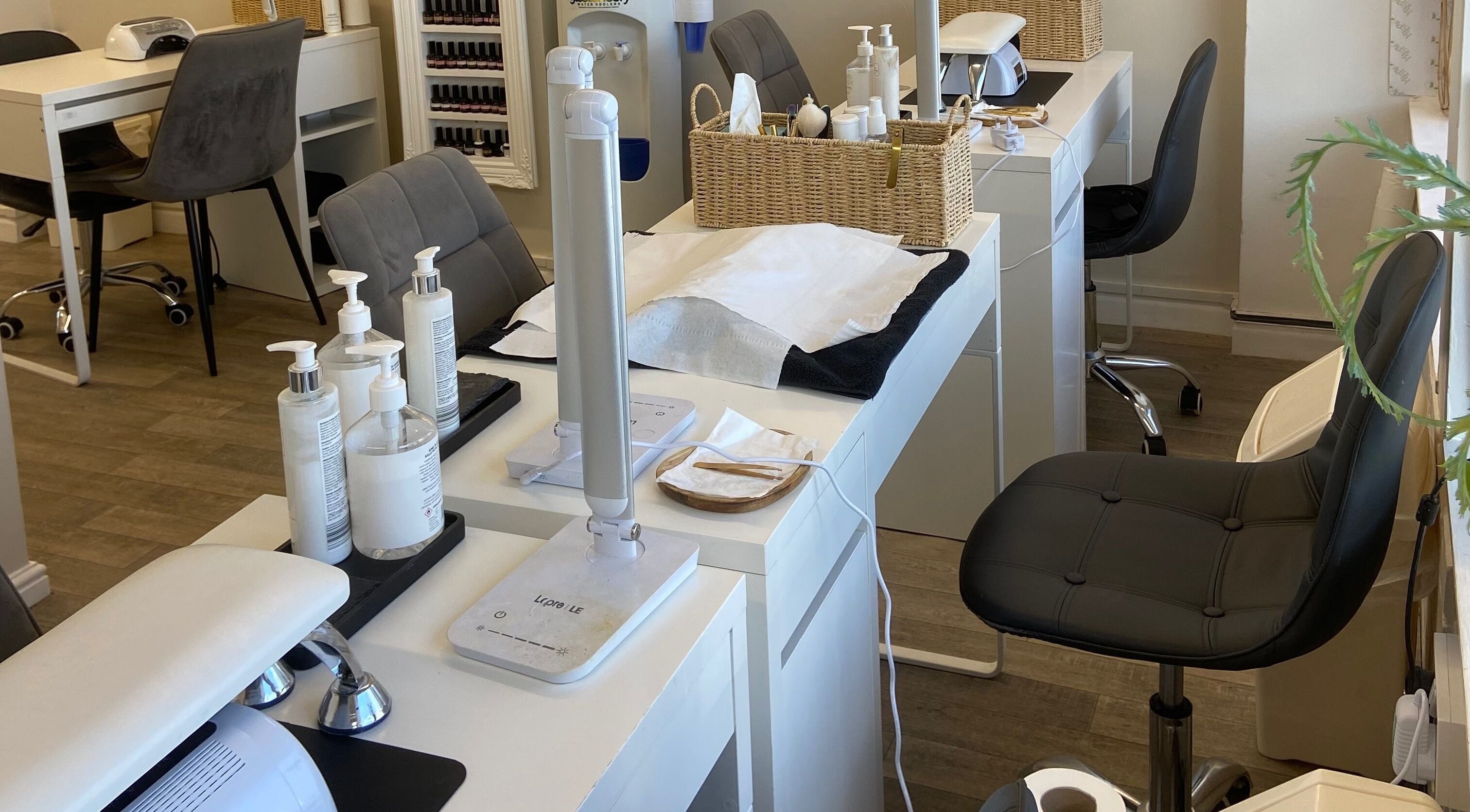 Elegant nail salon stations at Elm Tree Beauty in Westfield, England, GB, showcasing modern and tidy design.