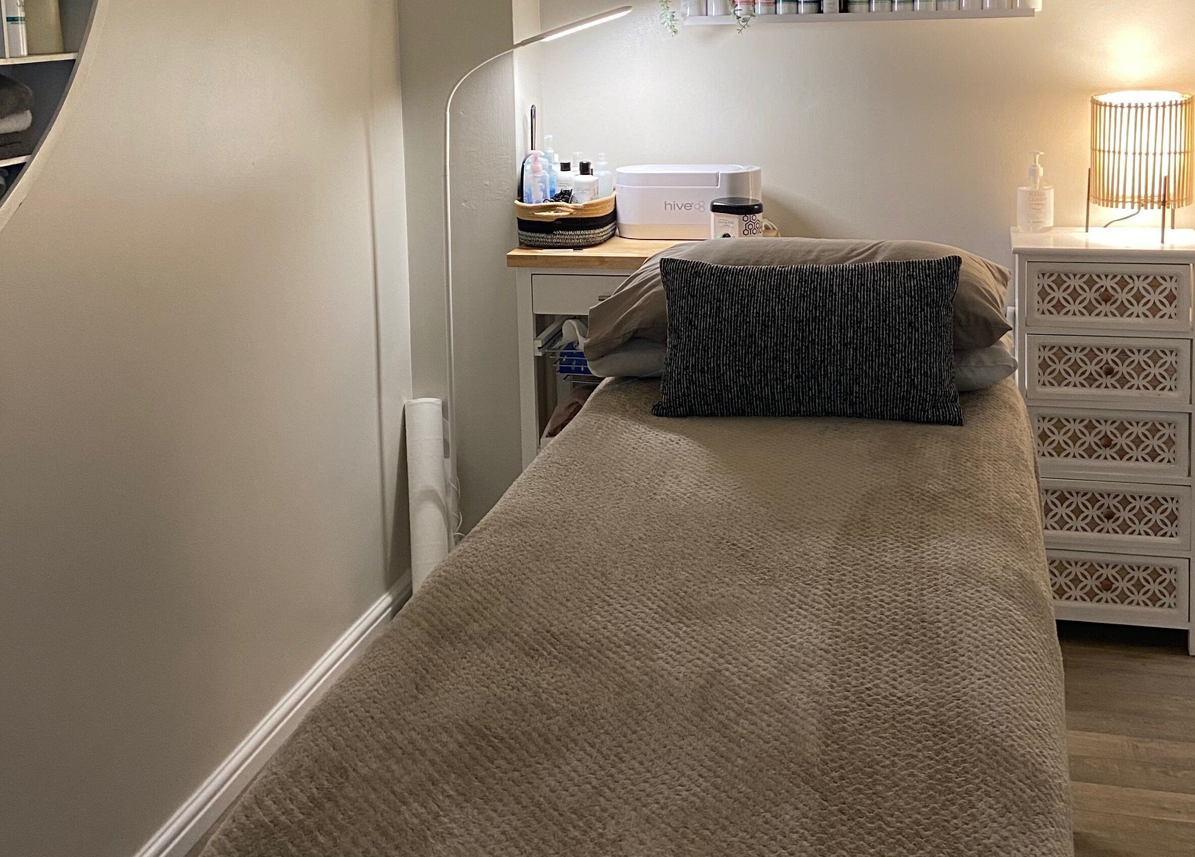 Cozy massage room at Elm Tree Beauty in Westfield, England, GB, featuring a treatment bed and soft lighting.