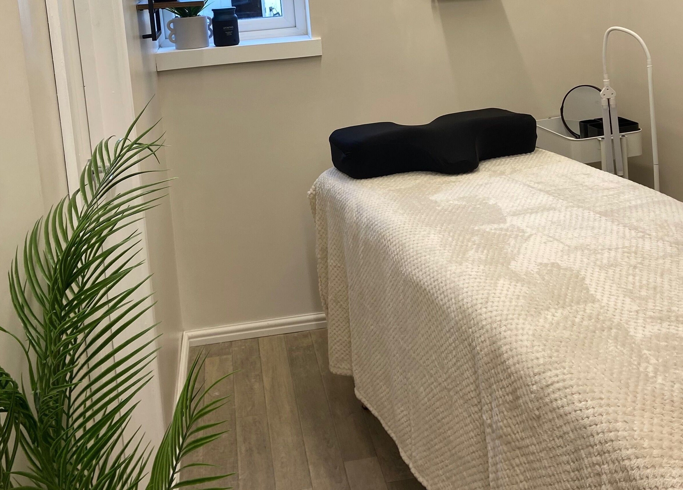Relaxing treatment room at Elm Tree Beauty, Westfield, England, GB, featuring a cozy bed and lush decor.