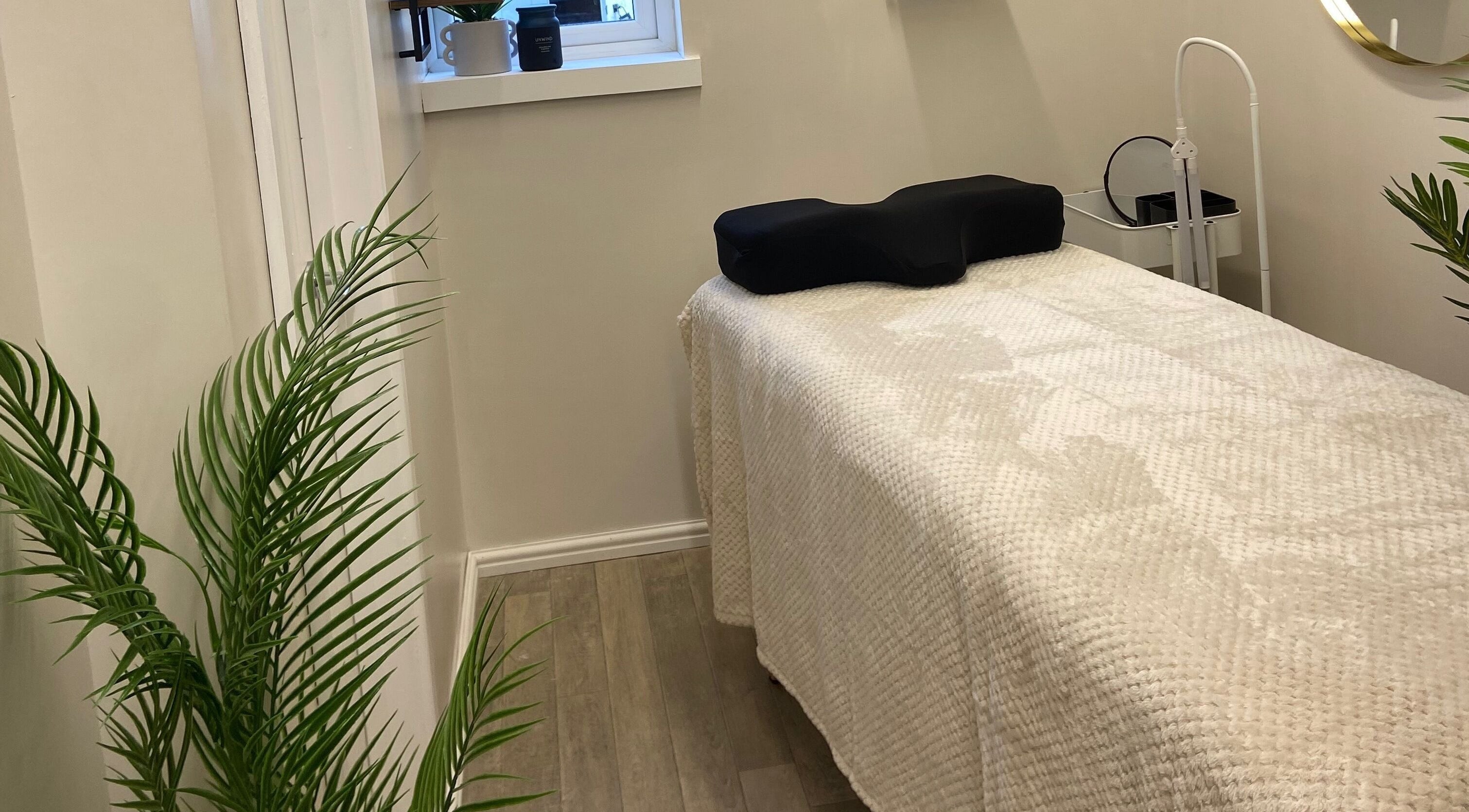 Relaxing treatment room at Elm Tree Beauty, Westfield, England, GB, featuring a cozy bed and lush decor.