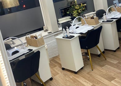 Elm Tree Beauty in Westfield, England, GB features chic manicure stations with plush chairs and modern decor.