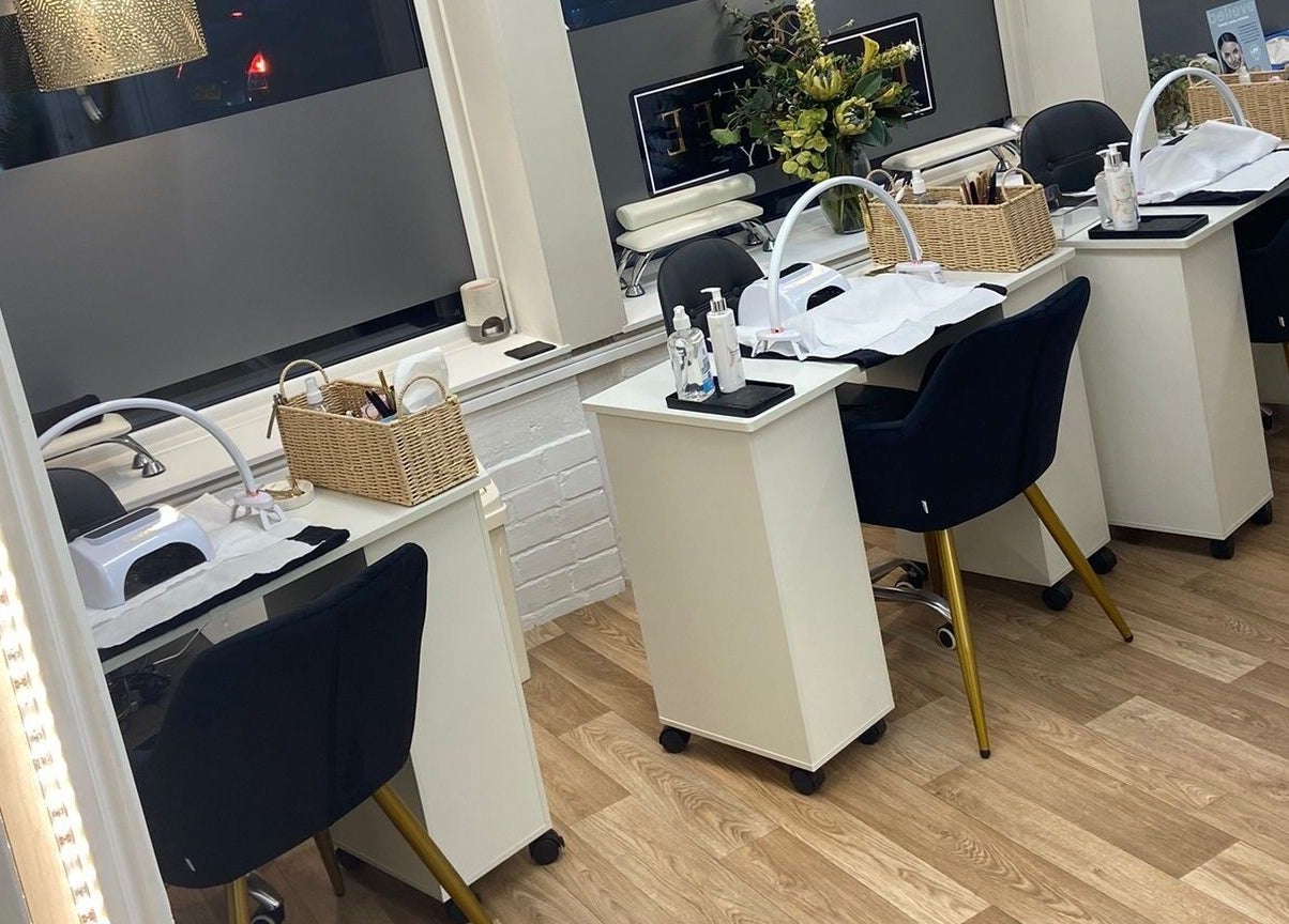 Elm Tree Beauty in Westfield, England, GB features chic manicure stations with plush chairs and modern decor.