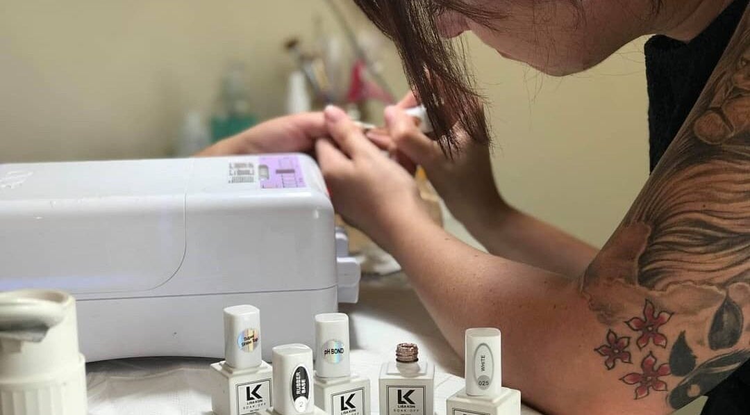 Nail artist applying polish at Tips 2 Toes Boutique, Wall Heath, England, GB.