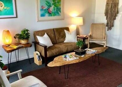 Cozy seating area at Caroline Altmann Massage Therapy, St. Augustine, Florida, US, with warm lighting and decor.