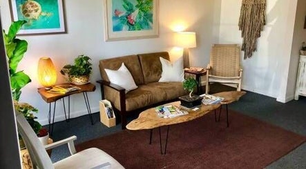 Cozy seating area at Caroline Altmann Massage Therapy, St. Augustine, Florida, US, with warm lighting and decor.