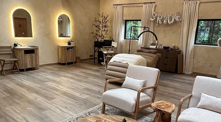 Elegant spa room at Mood Beauty Co., Brant, Ontario, CA, featuring warm lighting and cozy seating.