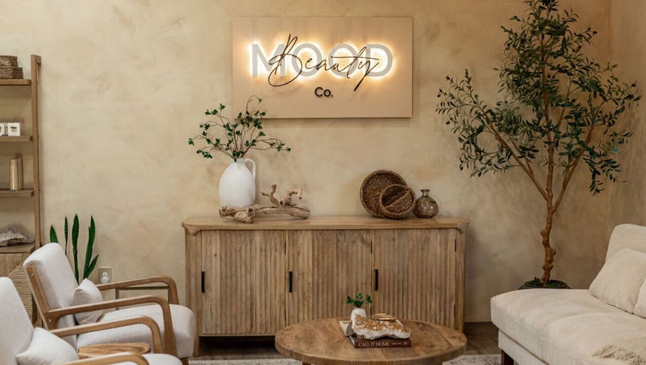 Cozy lounge at Mood Beauty Co., Brant, Ontario, CA with wooden furniture and decor.