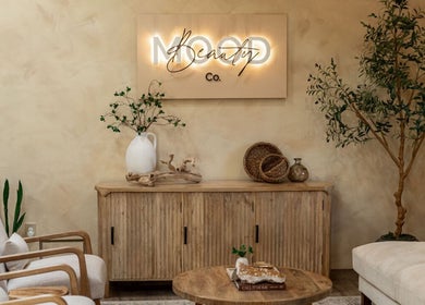Cozy lounge at Mood Beauty Co., Brant, Ontario, CA with wooden furniture and decor.