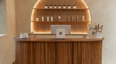 Reception desk at Mood Beauty Co., Brant, Ontario, CA, showcasing a modern wooden design with elegant decor.