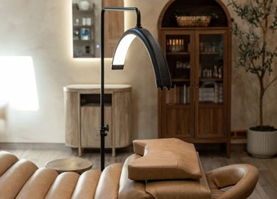 Relaxing spa room at Mood Beauty Co., Brant, Ontario, CA, with cozy leather chair and ambient lighting.