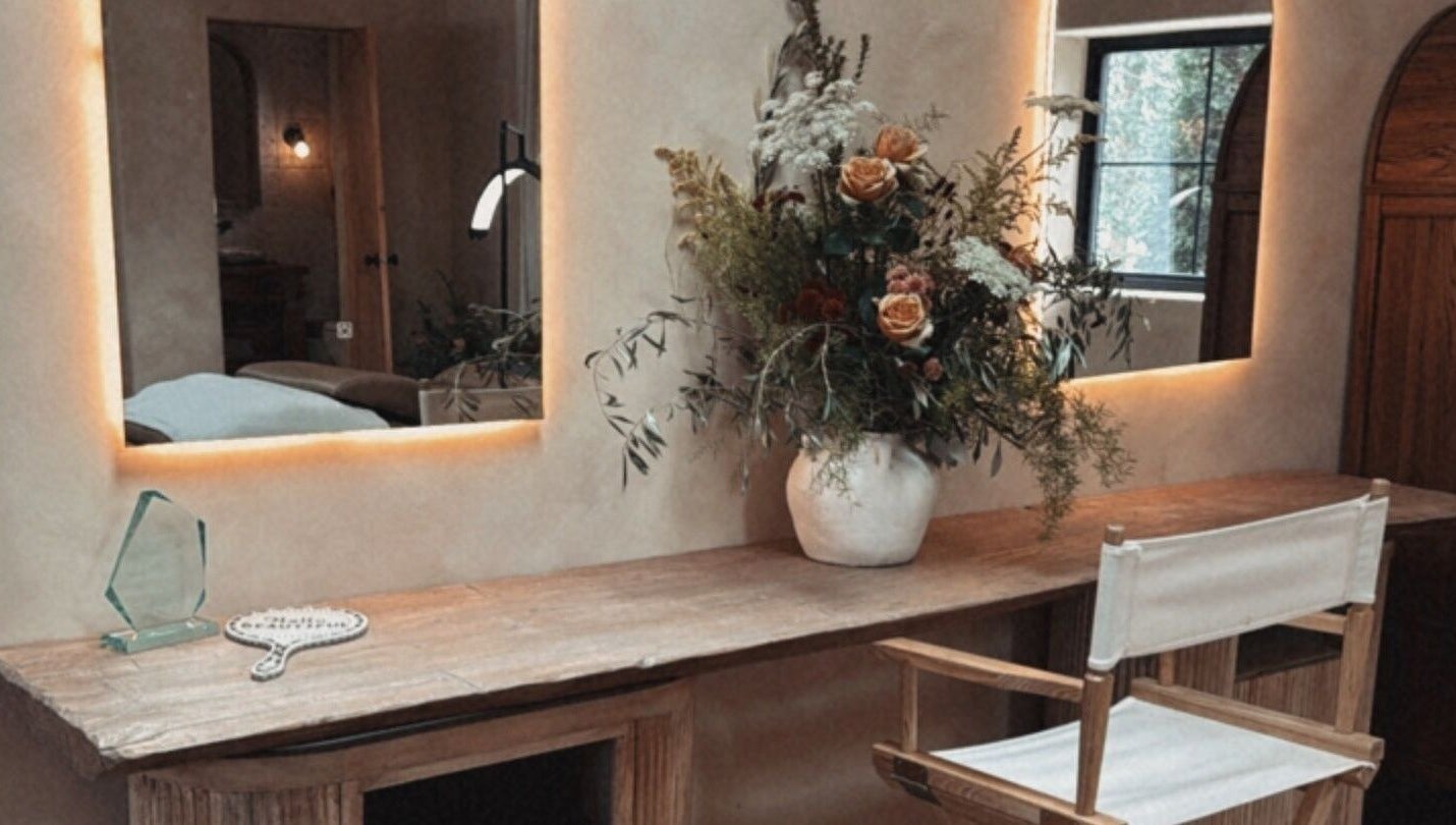 Elegant beauty station at Mood Beauty Co., Brant, Ontario, CA featuring warm lighting and floral decor.