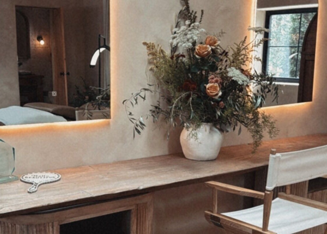 Elegant beauty station at Mood Beauty Co., Brant, Ontario, CA featuring warm lighting and floral decor.