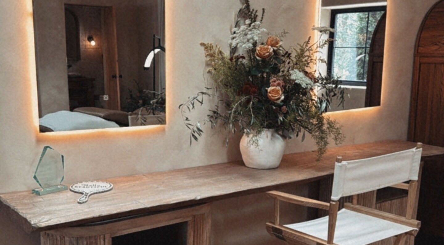 Elegant beauty station at Mood Beauty Co., Brant, Ontario, CA featuring warm lighting and floral decor.